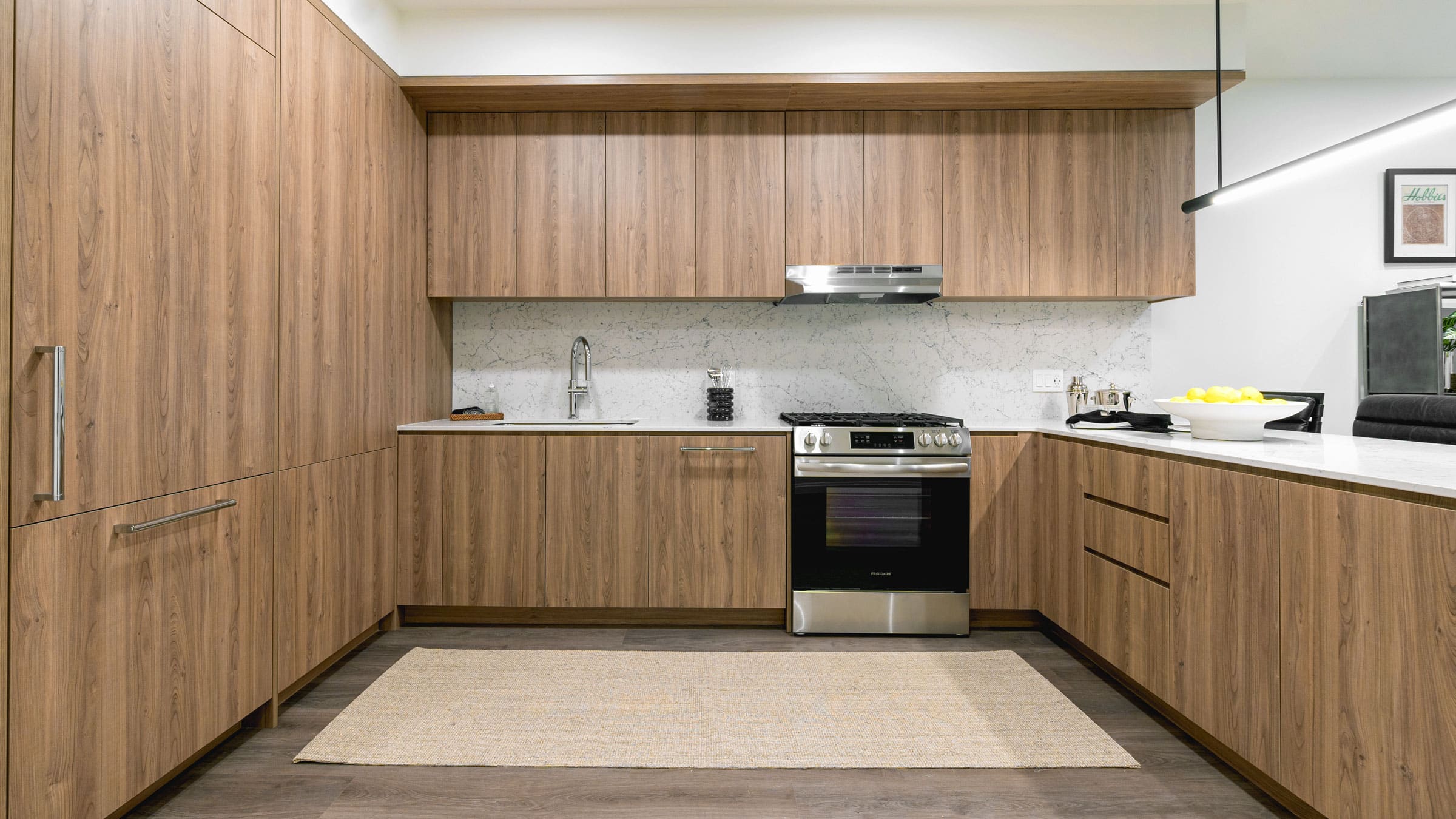 1000M apartments kitchen modern warm wood cabinetry and stainless steel appliances