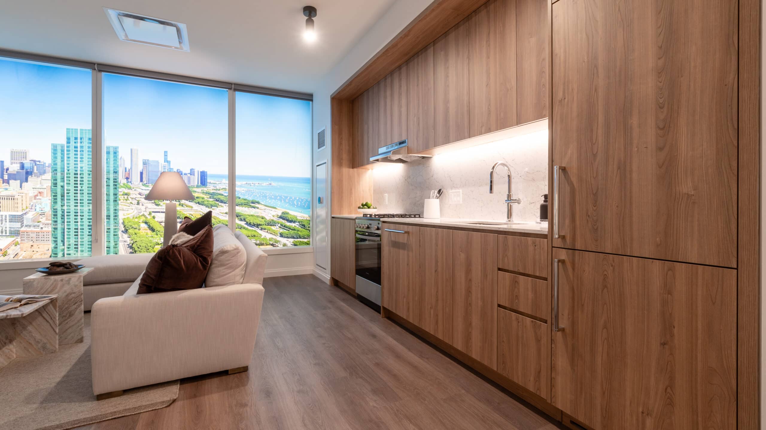 1000M kitchen and couch with lake michigan and grant park views through window